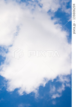 White fluffy cumulonimbus clouds floating in a vibrant blue sky on a bright sunny summer day, showcasing weather patterns and clear atmospheric conditions White fluffy cumulonimbus clouds floating in a vibrant blue sky on a bright sunny summer day, showcasing weather patterns and clear atmospheric conditions 139806204