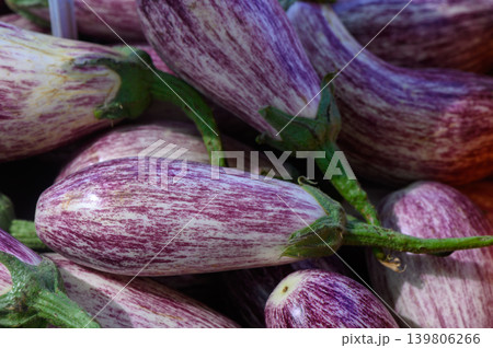 Colorful striped eggplants gather at a farmers market in the bright morning sun for culinary delights Colorful striped eggplants gather at a farmers market in the bright morning sun for culinary delights 139806266