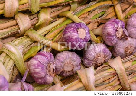 Garlic bunches displayed vibrantly at a bustling farmer's market in early autumn Garlic bunches displayed vibrantly at a bustling farmer's market in early autumn 139806275