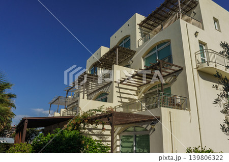 Contemporary architecture of a serene building under a blue sky during daytime. Contemporary architecture of a serene building under a blue sky during daytime. 139806322