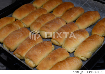 Top View of Latvian Pirozhki with Pork Fat and Onion on Baking Tray 139806413