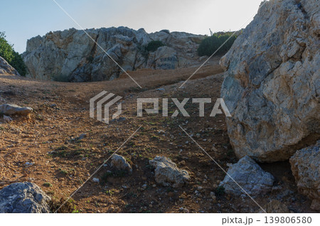 Exploring rugged terrain on a sunny day at the rocky hillside. Exploring rugged terrain on a sunny day at the rocky hillside. 139806580