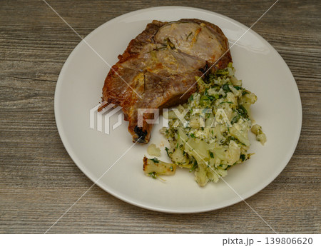 Golden Brown Pork Chop with Cauliflower Herb Side Dish Golden Brown Pork Chop with Cauliflower Herb Side Dish 139806620
