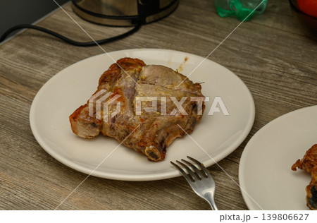 Bone-In Pork Chop with Seasoned Crust on White Plate Bone-In Pork Chop with Seasoned Crust on White Plate 139806627