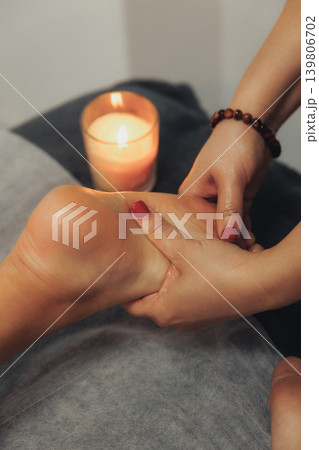 Hands massage foot with care and gentleness Hands massage foot with care and gentleness 139806702