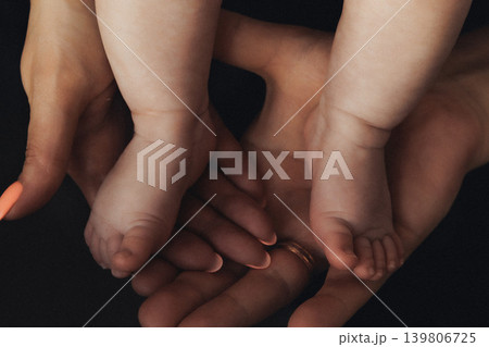 Soft hands cradle tiny feet with gentle care Soft hands cradle tiny feet with gentle care 139806725