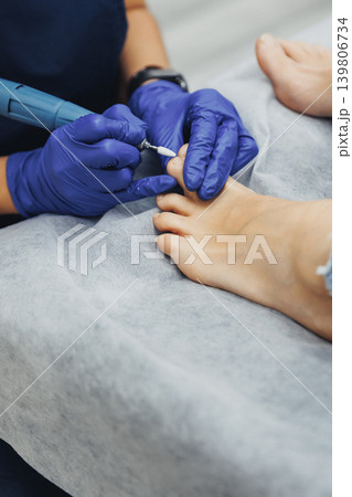 Professional technician cares for client's foot nails Professional technician cares for client's foot nails 139806734