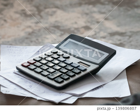 Calculator on paper with number notes. Accounting, finance calculations, tax preparation, budget management and business planning concept. Calculator on paper with number notes. Accounting, finance calculations, tax preparation, budget management and business planning concept. 139806807