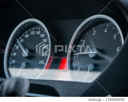 Close view of car dashboard with speedometer and tachometer gauges. Automotive interior for vehicle speed, engine RPM display. Close view of car dashboard with speedometer and tachometer gauges. Automotive interior for vehicle speed, engine RPM display. 139806992