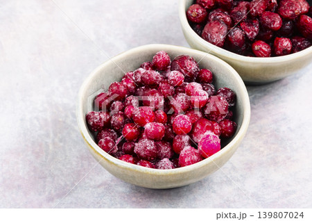Fresh Frozen Cranberries and Dried Cranberries on Ceramic Plate Fresh Frozen Cranberries and Dried Cranberries on Ceramic Plate 139807024
