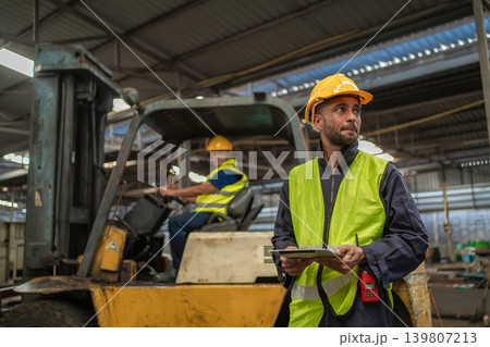 Man worker at forklift driver happy working in industry factory logistic ship. 139807213