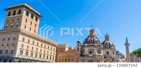Venice Palace and Church Domes near Trajans Column in Rome under Blue Sky. Old Italy street Architecture 139807342