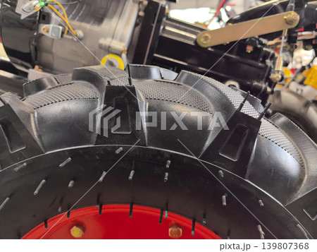 Close-up view of heavy-duty tire showing intricate tread design and construction 139807368