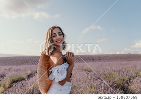 Woman lavender field smiling in a blooming garden with copy space for summer travel promotions and beauty concepts 139807669