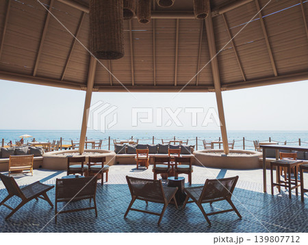 Beach bar pavilion in a Kemer resort offering seaside relaxation Beach bar pavilion in a Kemer resort offering seaside relaxation 139807712