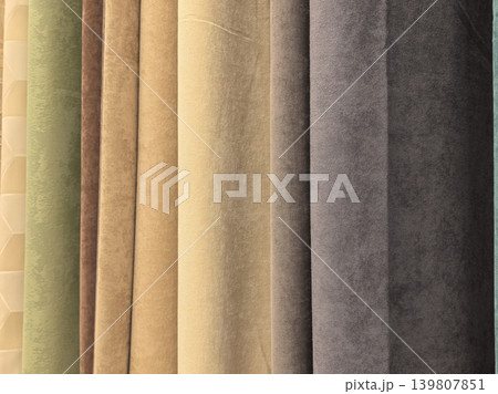 Colorful curtain drapery fabric samples hanging in store display Colorful curtain drapery fabric samples hanging in store display 139807851