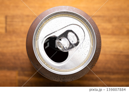 Open aluminum beverage can on wooden table Open aluminum beverage can on wooden table 139807884