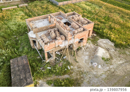 Aerial view of building site for future house, brick basement floor and stacks of brick for construction. Aerial view of building site for future house, brick basement floor and stacks of brick for construction. 139807956