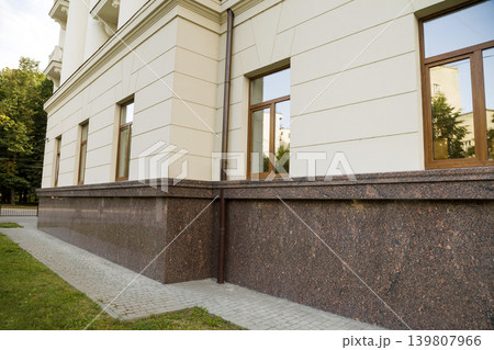 Close up view of part of a building facade with the surface of granite wall. Natural stone materials. 139807966