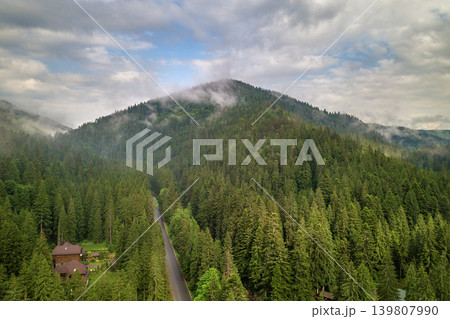 Aerial view of green Carpathian mountains covered with evergreen spruce pine foreston summer sunny day. Aerial view of green Carpathian mountains covered with evergreen spruce pine foreston summer sunny day. 139807990