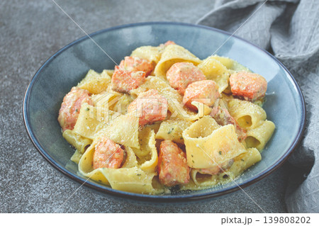 papardelle pasta, in creamy sauce with salmon, homemade, on a gray background, no people, papardelle pasta, in creamy sauce with salmon, homemade, on a gray background, no people, 139808202