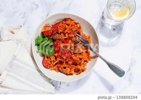 Bigos, Polish dish bigos, on a marble table, stewed meat with cabbage, chorizo sausages, mushrooms, homemade, without people, Bigos, Polish dish bigos, on a marble table, stewed meat with cabbage, chorizo sausages, mushrooms, homemade, without people, 139808204