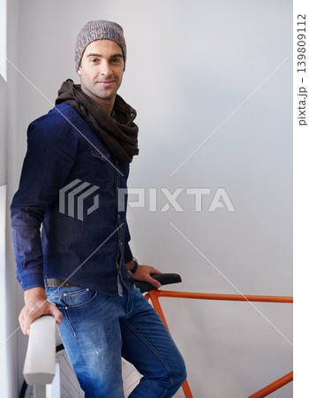 Portrait, fashion and bike with man in stairs of apartment for travel, transport or commute. Home, sustainability and zero emission bicycle with confident young person on steps in winter style Portrait, fashion and bike with man in stairs of apartment for travel, transport or commute. Home, sustainability and zero emission bicycle with confident young person on steps in winter style 139809112