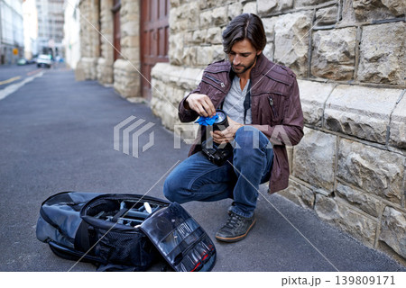 Clean, camera lens and photographer work with equipment outdoor and prepare for photoshoot in city. Cameraman, wipe and start project with gear for photography on town street for professional media Clean, camera lens and photographer work with equipment outdoor and prepare for photoshoot in city. Cameraman, wipe and start project with gear for photography on town street for professional media 139809171