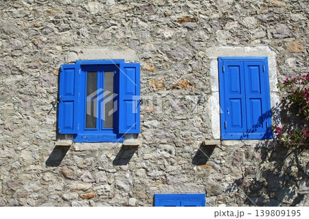 house with blue windows on stone house. house with blue windows on stone house. 139809195