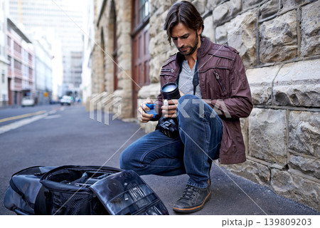 Camera lens, equipment and photographer in city for photoshoot with gear on street. Cameraman, cleaning and prepare professional photography tools for project and person with technology on road Camera lens, equipment and photographer in city for photoshoot with gear on street. Cameraman, cleaning and prepare professional photography tools for project and person with technology on road 139809203