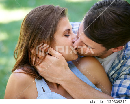Man, woman and kiss with embrace in park for holiday vacation or relationship connection, bonding or summer. Happy couple, hug and love in backyard garden for marriage care, together or partnership Man, woman and kiss with embrace in park for holiday vacation or relationship connection, bonding or summer. Happy couple, hug and love in backyard garden for marriage care, together or partnership 139809212