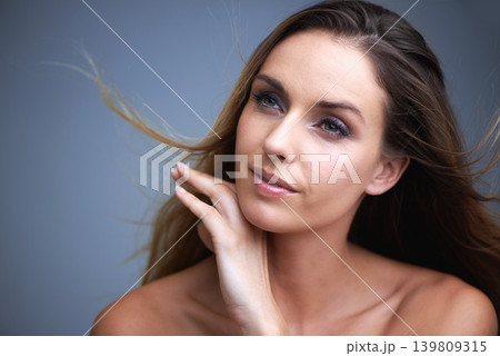 Woman, face and natural beauty in skincare, cosmetics or makeup on a blue studio background. Happy or attractive female person, brunette or model with smile for haircare or facial treatment on mockup Woman, face and natural beauty in skincare, cosmetics or makeup on a blue studio background. Happy or attractive female person, brunette or model with smile for haircare or facial treatment on mockup 139809315