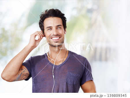 Man, fashion and smile with earphones for music, podcast or streaming online on mockup. Male person, happy and listening to audio on headphones for enjoyment, fun and wellness outdoors in nature Man, fashion and smile with earphones for music, podcast or streaming online on mockup. Male person, happy and listening to audio on headphones for enjoyment, fun and wellness outdoors in nature 139809345