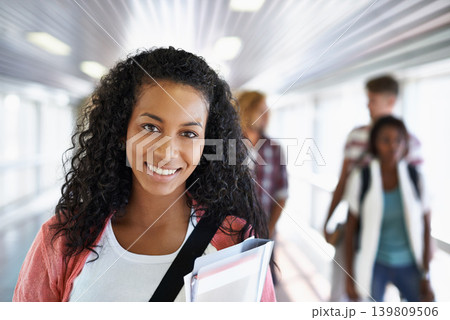 Woman, student and smile on college campus, portrait and ready for university and education. Female person, scholarship and learning or start school, academy and preparing for studying in hallway 139809506