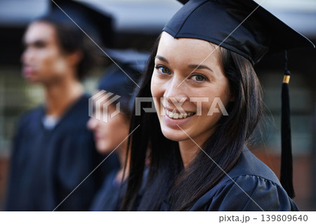 Woman, student and portrait at graduation, college and university success or achievement. Happy female person, smile and pride at outdoor ceremony, higher education and knowledge in qualification 139809640