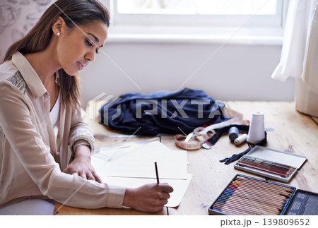 Fashion designer, woman and drawing on paper with pencil in startup office of small business. Creative, person or tailor sketch at desk for illustration project, planning or writing draft for clothes Fashion designer, woman and drawing on paper with pencil in startup office of small business. Creative, person or tailor sketch at desk for illustration project, planning or writing draft for clothes 139809652