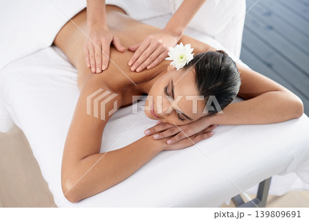 Woman, back massage and body treatment for relaxing, wellness and muscle therapy for bodycare. Female person, masseuse and health by dermatology, calm and resting at resort hotel and peace or zen 139809691
