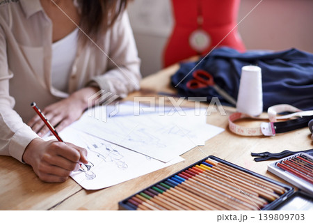Fashion designer, hands and sketch on paper with pencil in startup office of small business. Creative, person or tailor drawing at desk for illustration project, planning or writing draft for clothes 139809703