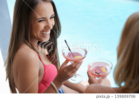 Friends, women and laughing with alcohol at pool, bonding and drinking wine on vacation. People, communication and cocktail for funny conversation on summer holiday, weekend trip and travel to resort Friends, women and laughing with alcohol at pool, bonding and drinking wine on vacation. People, communication and cocktail for funny conversation on summer holiday, weekend trip and travel to resort 139809706