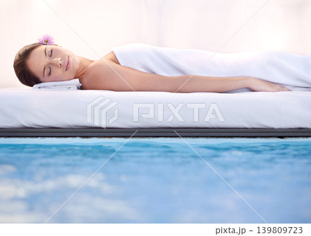 Relax, sleep and woman at spa pool with massage for health, wellness balance and luxury holistic treatment. Self care, peace and girl on poolside bed for body therapy, comfort and calm hotel service 139809723