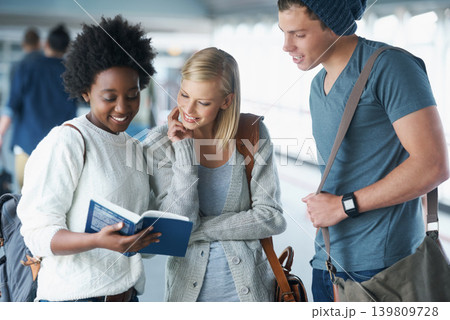 Students, friends and reading in hallway at college with books for education, learning or knowledge. University, scholar or people with smile for break, relax or diversity for scholarship in corridor Students, friends and reading in hallway at college with books for education, learning or knowledge. University, scholar or people with smile for break, relax or diversity for scholarship in corridor 139809728