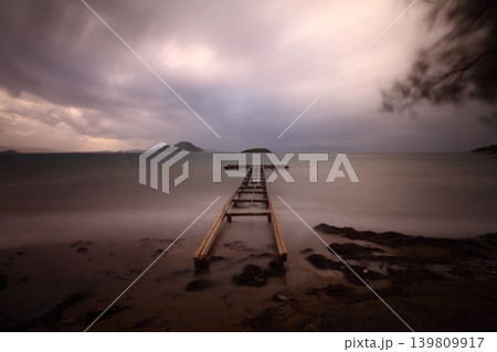old, rusty abandoned and dismantled pier. sky space is empty. suitable for writing. Seaside town of Turgutreis and spectacular sunshine. Long Exposure shoot. tranquility scene. old, rusty abandoned and dismantled pier. sky space is empty. suitable for writing. Seaside town of Turgutreis and spectacular sunshine. Long Exposure shoot. tranquility scene. 139809917