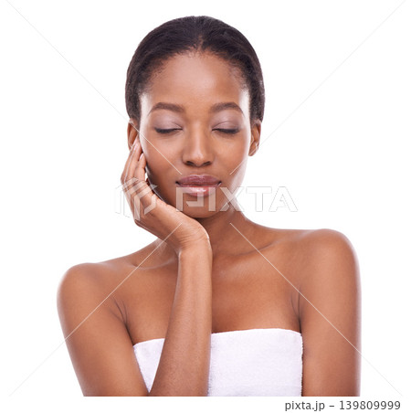 Skincare, touch and beauty of black woman with eyes closed for glow isolated on a white studio background. Hands, makeup and model in cosmetics, dermatology and spa facial treatment for smooth skin Skincare, touch and beauty of black woman with eyes closed for glow isolated on a white studio background. Hands, makeup and model in cosmetics, dermatology and spa facial treatment for smooth skin 139809999