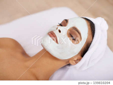 Woman, clay mask and facial for skincare in spa, detox and cosmetic treatment for beauty or health. Person, relax or dermatology with natural cleaning on skin, soothing or zen with wellness in salon Woman, clay mask and facial for skincare in spa, detox and cosmetic treatment for beauty or health. Person, relax or dermatology with natural cleaning on skin, soothing or zen with wellness in salon 139810204