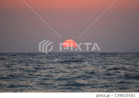 Close-up of empty sky and sun for copy space. The spectacular view of the sunset was breathtaking, with the sun sinking behind the clouds on the horizon. 139810381