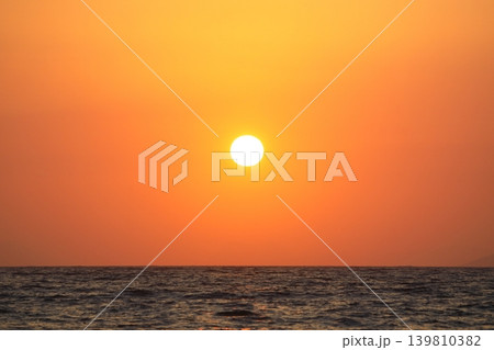 Close-up of empty sky and sun for copy space. The spectacular view of the sunset was breathtaking, with the sun sinking behind the clouds on the horizon. 139810382