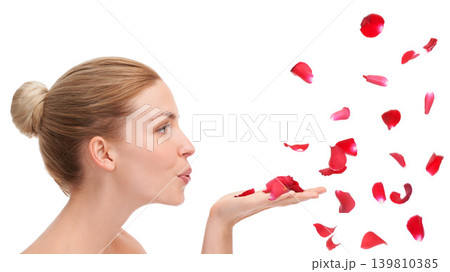 Woman, studio and blow with rose petals in profile for natural beauty, skincare or wellness by white background. Girl, model or person with flowers for celebration, organic confetti or Valentines Day 139810385