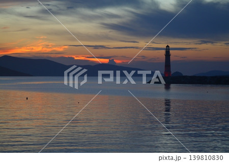 Seascape at sunshine. Lighthouse and sailings on the coast. Seaside town of Turgutreis and spectacular sunshine 139810830