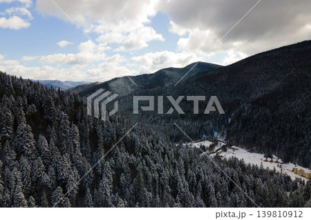 Winter landscape with spruse trees of snow covered forest in cold mountains. Winter landscape with spruse trees of snow covered forest in cold mountains. 139810912