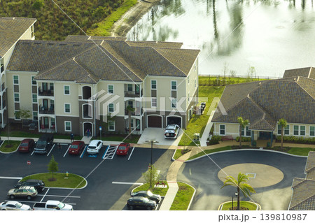 Aerial view of american apartment buildings in Florida residential area. New family condos as example of housing development in US suburbs Aerial view of american apartment buildings in Florida residential area. New family condos as example of housing development in US suburbs 139810987